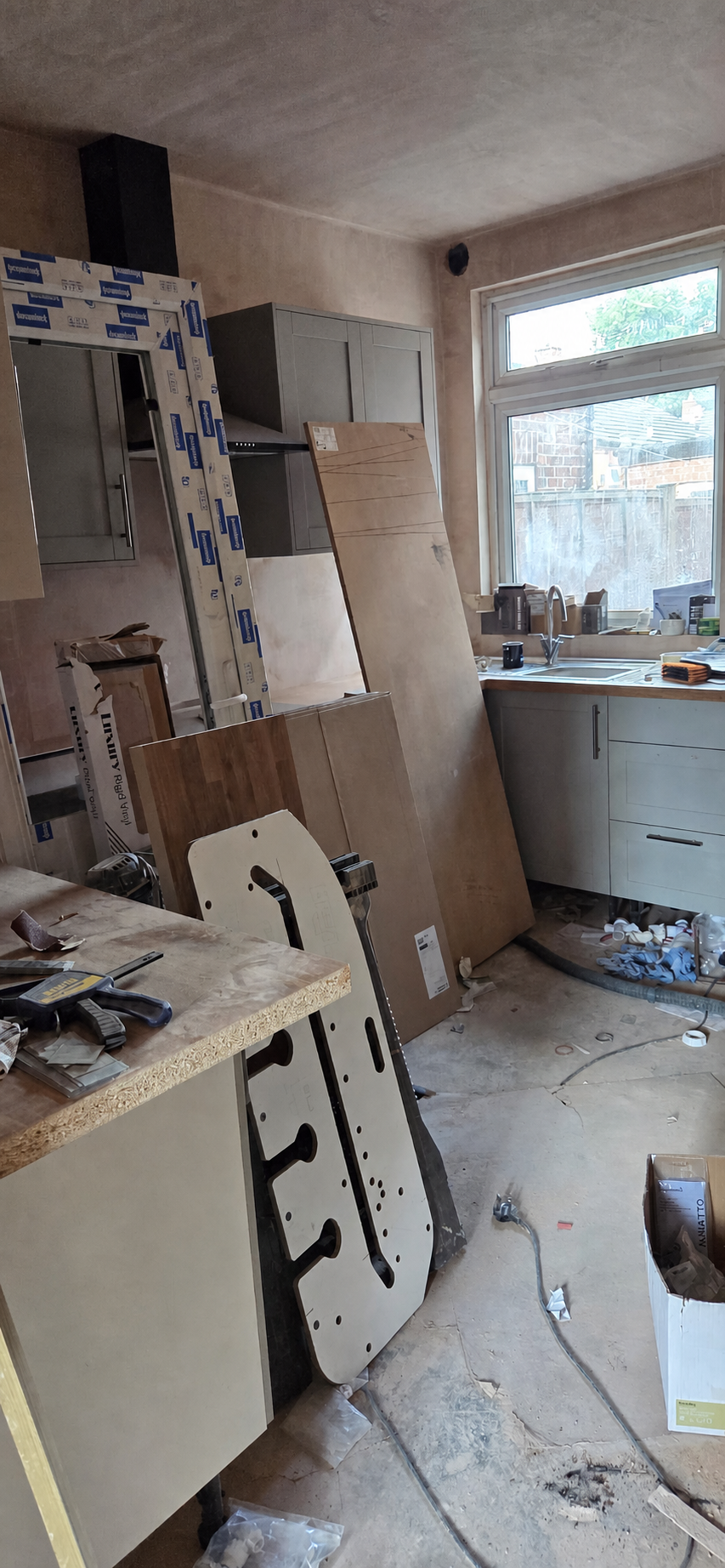Kitchen during refurbishment with materials and unfinished flooring