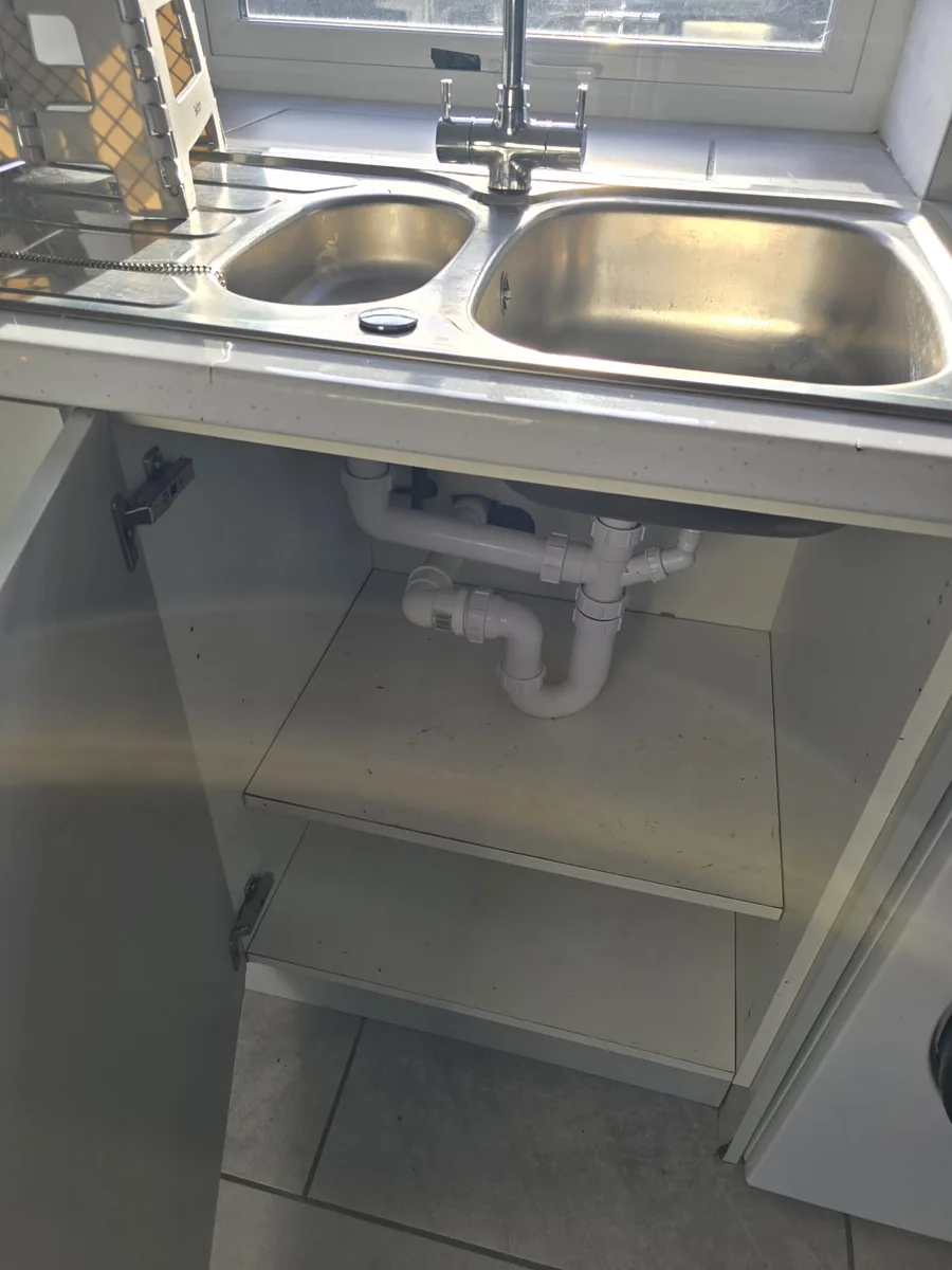Main Street double sink and emptied cupboard after clearance and cleaning work